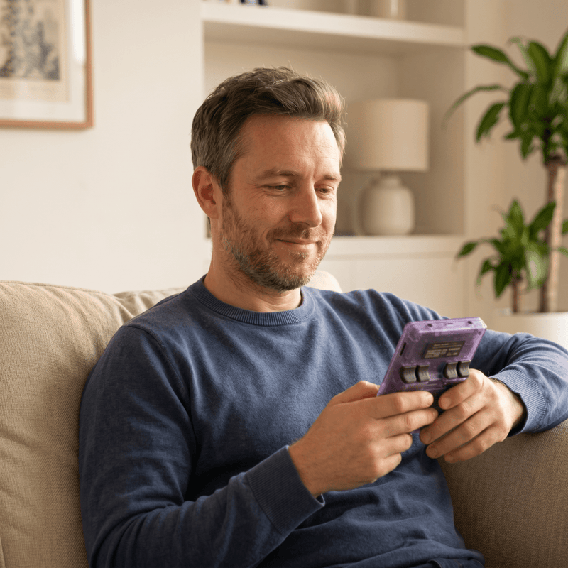 Person playing the Qevrisa Pro 2.0 R36S retro gaming console at home